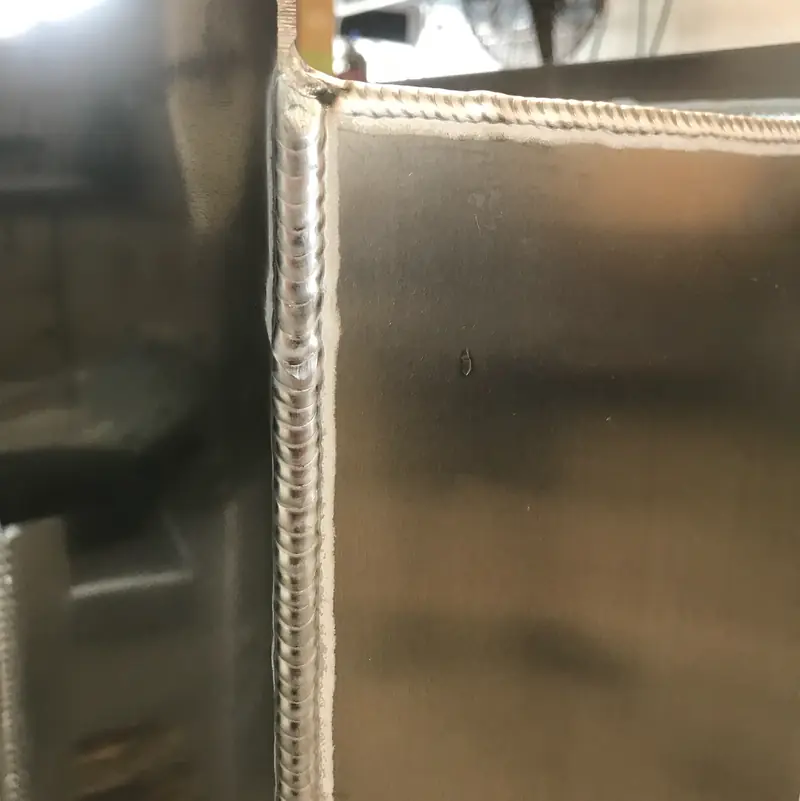 Close-up of a TIG weld bead on an aluminum tank seam