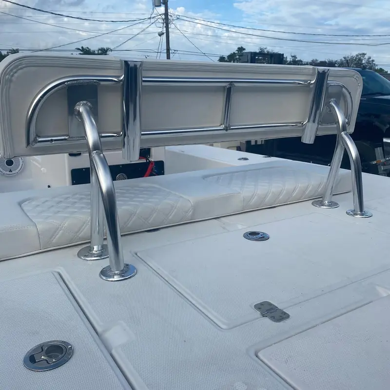 Close-up of a welded seat backrest frame on a flats boat deck