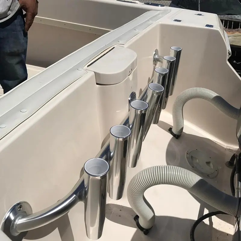 Transom rod holders mounted behind the outboard motors