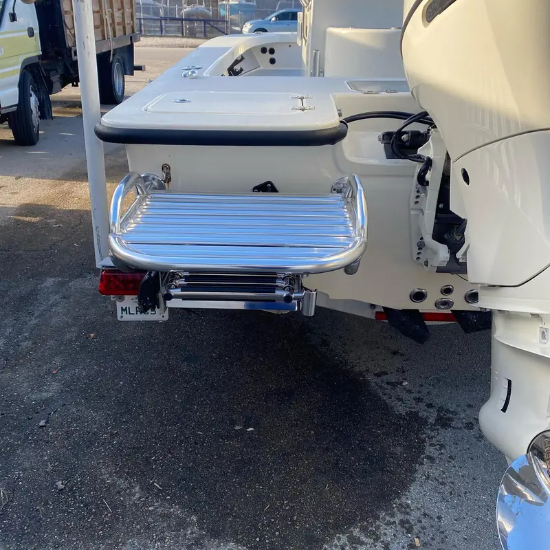 Port-side transom swim platform and ladder beside a single outboard