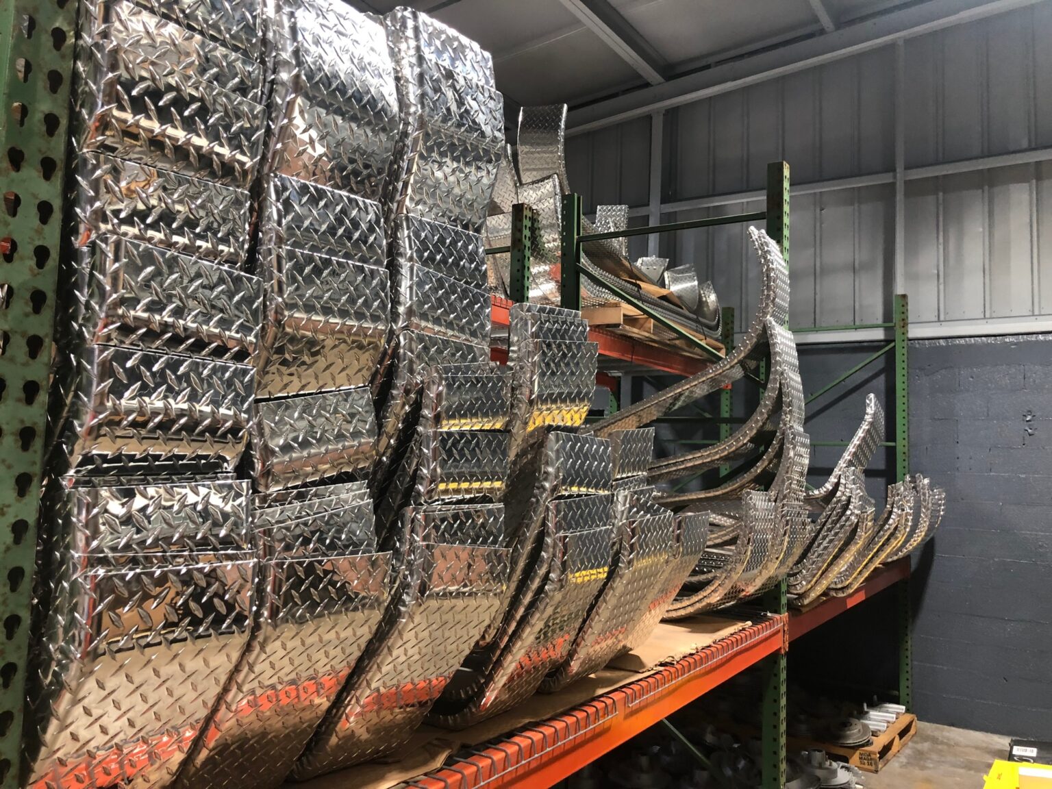 Aluminum diamond plate fenders racked at the Rocket factory